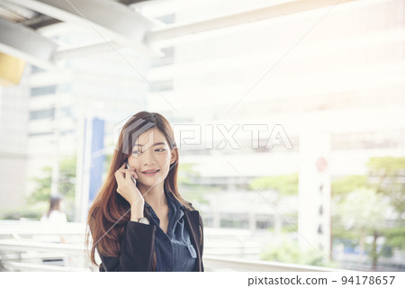 Business woman using smartphone shopping online, call, texting message internet technology lifestyle. Asian woman using cellphone walking on city street. Smart phone smart confident woman modern city 94178657
