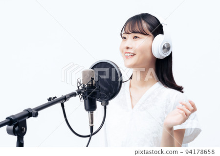 Young woman singing with white headphones Young woman singing with white headphones 94178658