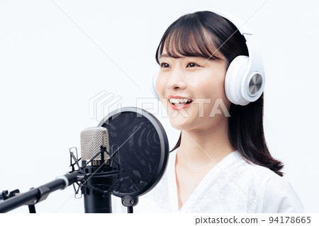 Young woman singing with white headphones Young woman singing with white headphones 94178665