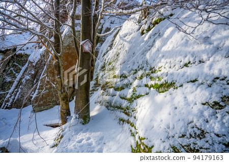 Granite rock formation covered by snow Granite rock formation covered by snow 94179163