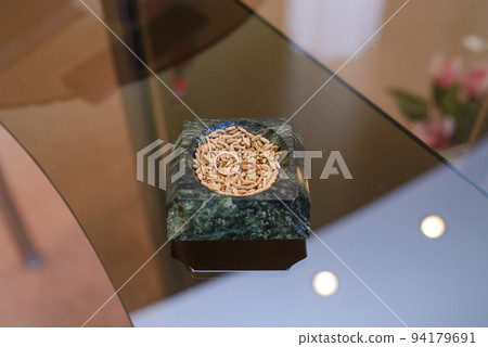Wedding rings are in a saucer with grain. Russian tradition Wedding rings are in a saucer with grain. Russian tradition 94179691