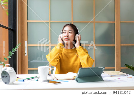 Young woman happy listen music for chill and relax after finish work. Young woman happy listen music for chill and relax after finish work. 94181042