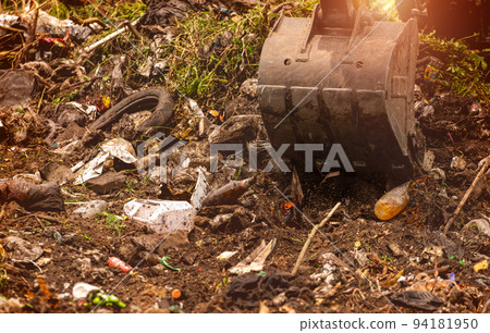 Backhoe digging soil at construction site. Bucket of backhoe digging soil. Digger working landfill work. Excavating machine. Earth moving machine. Excavation vehicle. Digger at construction site. 94181950