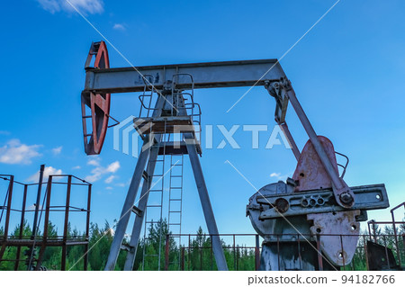 An abandoned oil or gas rocking machine against a 94182766
