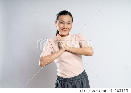 Asian woman guilty holding hands in prayer isolated on background. Asian woman guilty holding hands in prayer isolated on background. 94183115
