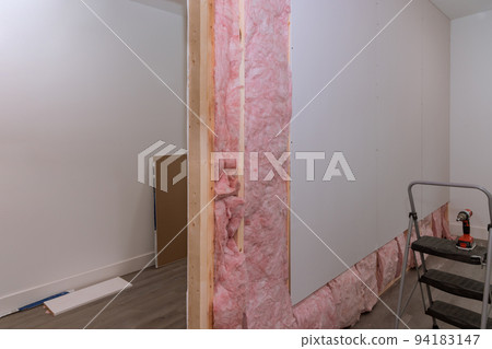 Screwing drywall on beams framing after installing sound and thermal insulation 94183147