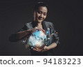 Asian woman showing a growing virtual hologram of statistics, graph and chart. 94183223