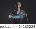 Asian woman showing a growing virtual hologram of statistics, graph and chart. 94183226