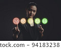 Asian woman voting and pressing angry face emoticon on virtual touch screen, isolated on background. 94183238