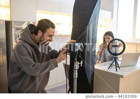 Cameraman and a video blogger preparing for shooting a vlog Cameraman and a video blogger preparing for shooting a vlog 94183309
