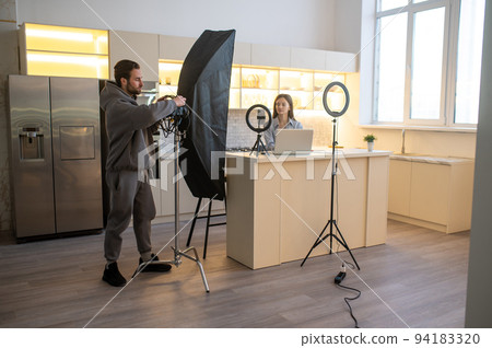 Video blogger and her assistant preparing for shooting a video 94183320