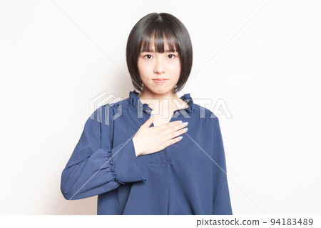 白色背景前手放在胸前的年輕女子 94183489