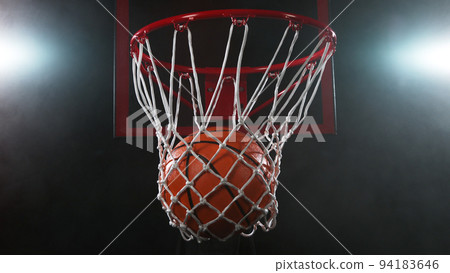 Detail of basketball ball hitting the basket. 94183646