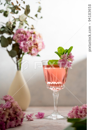Pink drink cocktails, liquor or gin. Pink sangria fruity wine with hydrangea pink flowers. Bright, girly background 94183658