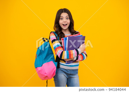 Schoolgirl, teenage student girl hold book on yellow isolated studio background. School and education concept. Back to school. Happy teenager, positive and smiling emotions of teen girl. Schoolgirl, teenage student girl hold book on yellow isolated studio background. School and education concept. Back to school. Happy teenager, positive and smiling emotions of teen girl. 94184044