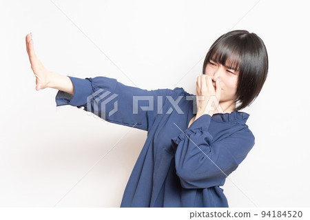 A young woman pinching her nose because of a bad smell 94184520