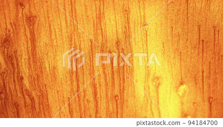 Glitter fluid background. Color sand texture. Shimmering sparkles drip. Orange yellow shiny particles abstract copy space wallpaper. 94184700