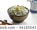 Whitebait rice bowl topped with grated ginger, chopsticks and soy sauce jug 94185643