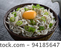 Close-up of boiled whitebait bowl topped with egg 94185647
