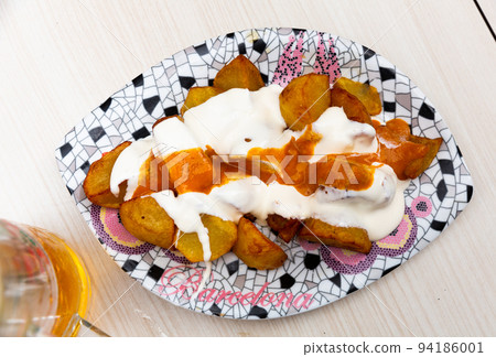 Spicy fried potatoes Patatas bravas with sauces Spicy fried potatoes Patatas bravas with sauces 94186001