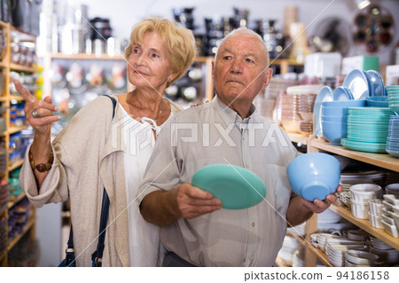 Couple elderly customers buying dishes Couple elderly customers buying dishes 94186158
