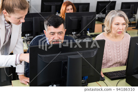 Female teacher explaining to mature man 94186310