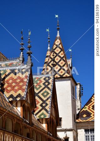 Beaune, France. "Hospices de Beaune" is characterized by its beautiful roof. Taken on August 8, 2022. 94186399