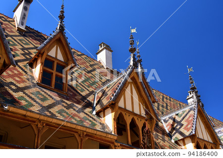 Beaune, France. "Hospices de Beaune" is characterized by its beautiful roof. Taken on August 8, 2022. 94186400