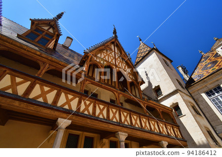 Beaune, France. "Hospices de Beaune" is characterized by its beautiful roof. Taken on August 8, 2022. 94186412