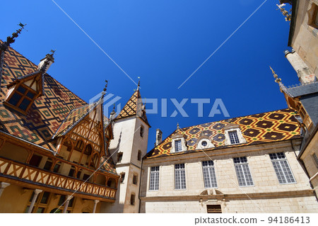 Beaune, France. "Hospices de Beaune" is characterized by its beautiful roof. Taken on August 8, 2022. 94186413