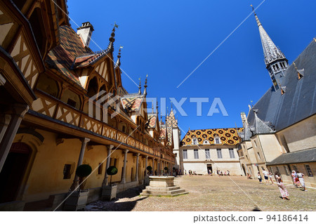 Beaune, France. "Hospices de Beaune" is characterized by its beautiful roof. Taken on August 8, 2022. 94186414