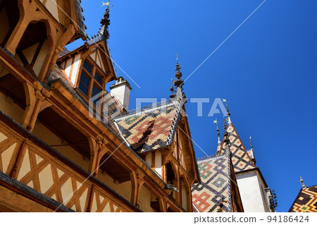Beaune, France. "Hospices de Beaune" is characterized by its beautiful roof. Taken on August 8, 2022. 94186424