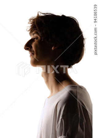 Side view portrait of young man with mustache posing isolated over white studio background. Silhouette 94186539