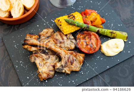 Fried lamb grilled with corn on black background top view close up 94186626
