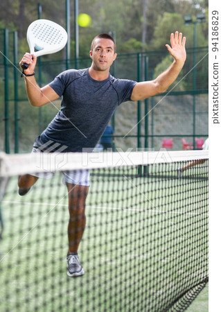 Man in sportswear playing padel tennis match 94186829