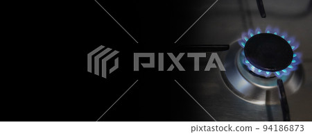 Banner of a close-up of a flame of methane gas stove in a domestic kitchen with black background to insert your text, related with gas price energy crisis in europe for an expensive costs. Banner of a close-up of a flame of methane gas stove in a domestic kitchen with black background to insert your text, related with gas price energy crisis in europe for an expensive costs. 94186873