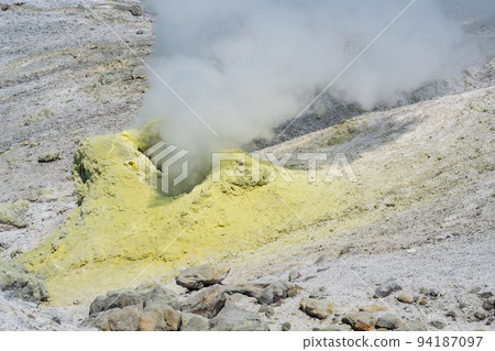 steaminf fumarola in a solfataric field on a slope of the volcano 94187097