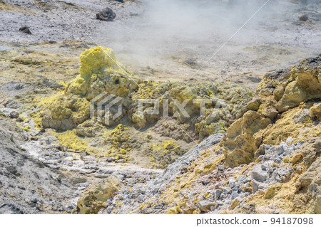 sulfur deposits around a solfatara in a fumarole field on the slope of a volcano sulfur deposits around a solfatara in a fumarole field on the slope of a volcano 94187098