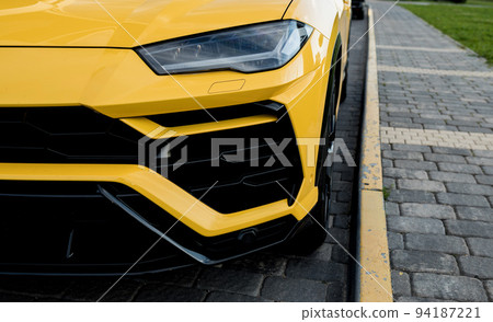 Headlights and hood of sport yellow car 94187221