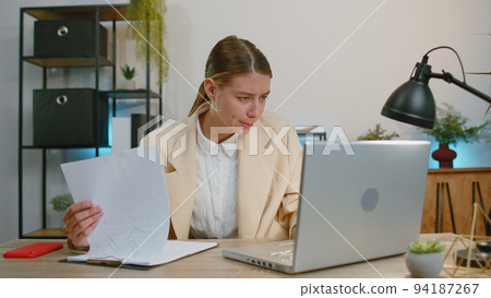 Stressed business woman worried about financial paperwork problem money debt budget loss at office Stressed business woman worried about financial paperwork problem money debt budget loss at office 94187267