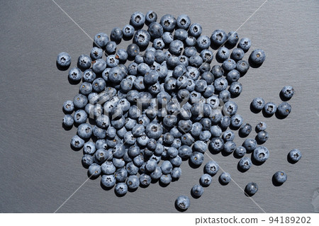 Food background. Ripe blueberries scattered on slate plate . Food background. Ripe blueberries scattered on slate plate . 94189202