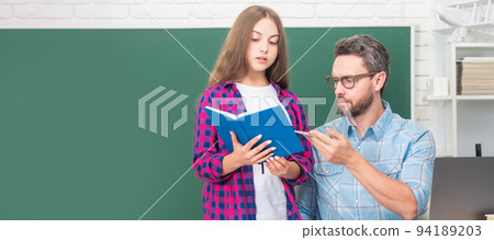 Father and daughter at school, teacher and pupil banner. dad and daughter use notebook. back to school. childhood education. Father and daughter at school, teacher and pupil banner. dad and daughter use notebook. back to school. childhood education. 94189203