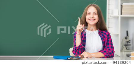 inspired with idea child study at school on blackboard background, education. Banner of schoolgirl student. School child pupil portrait with copy space. inspired with idea child study at school on blackboard background, education. Banner of schoolgirl student. School child pupil portrait with copy space. 94189204