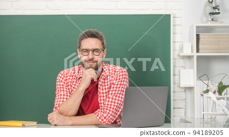 mature man teacher in glasses at blackboard, school mature man teacher in glasses at blackboard, school 94189205