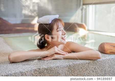 Woman resting by the pool Woman resting by the pool 94189897