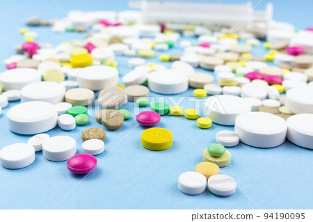 pills on a blue background pills on a blue background 94190095