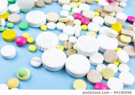 pills on a blue background pills on a blue background 94190096