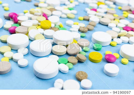 pills on a blue background pills on a blue background 94190097