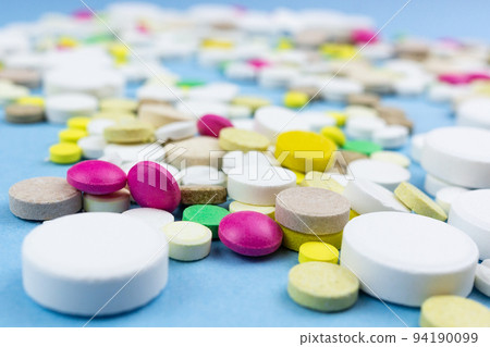 pills on a blue background pills on a blue background 94190099
