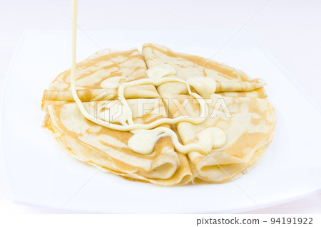 Pancakes drenched with condensed milk Pancakes drenched with condensed milk 94191922